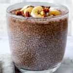 Coffee chia pudding with banana, nuts, and chocolate in a glass jar
